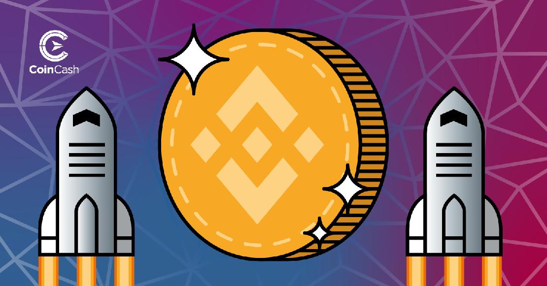 Két szürke rakéta, középen egy fényes érme Binance Coin logóval.